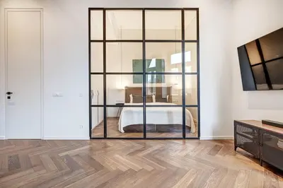 a room with a glass partition with a bed in it at Boutique apartment in Old Town in Vilnius
