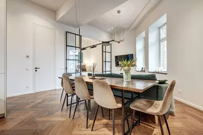 a dining room with a table and chairs at Boutique apartment in Old Town in Vilnius