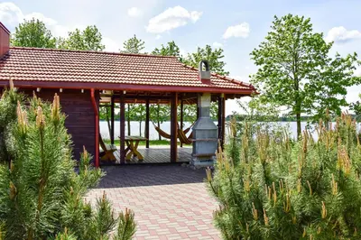 a pavilion with a table and a stove at Sodyba Pas Drambliuka in Svėdasai
