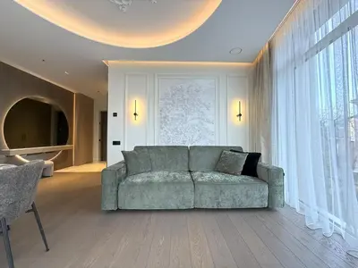 a living room with a couch and a large window at Apartment near Hospital Kaunas Clinics in Kaunas