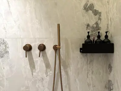 a wall with a shelf with bottles on it at Apartment near Hospital Kaunas Clinics in Kaunas