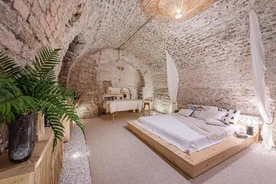 a bedroom with a bed in a brick wall at Aura Spa in Vilnius