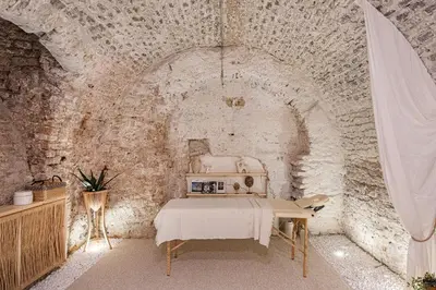 a room with a sewing machine in a stone wall at Aura Spa in Vilnius