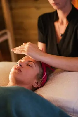 a woman laying on a couch with her hand on her head at Aura Spa in Vilnius