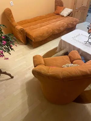 a living room with two brown chairs and a couch at Ground floor apartment close to city centre and tourist attractions in Druskininkai