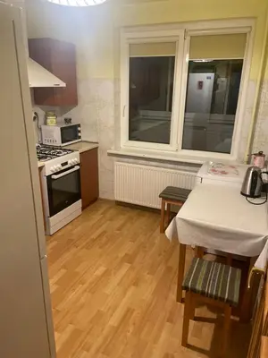 a small kitchen with a table and a window at Ground floor apartment close to city centre and tourist attractions in Druskininkai