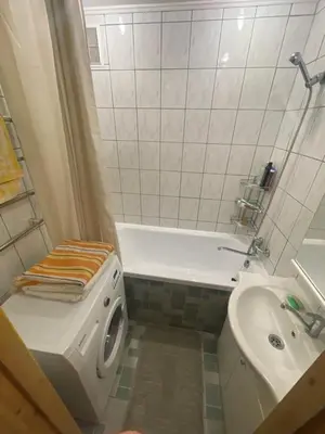 a bathroom with a toilet and a tub and a sink at Ground floor apartment close to city centre and tourist attractions in Druskininkai