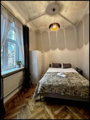 a bedroom with a bed and a window at Kauno Centras in Kaunas