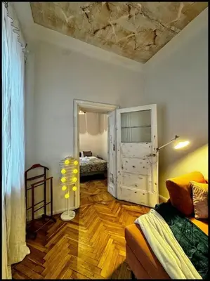 a living room with a couch and a bed in a room at Kauno Centras in Kaunas