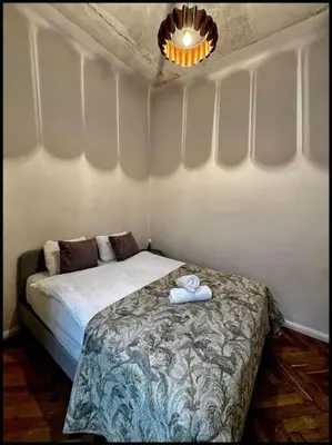 a bedroom with a bed with a towel on it at Kauno Centras in Kaunas