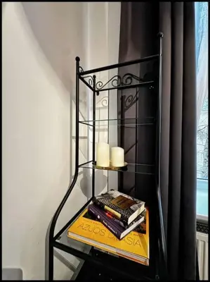a shelf with candles and books on a table at Kauno Centras in Kaunas