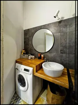 a bathroom with a sink and a washing machine at Kauno Centras in Kaunas