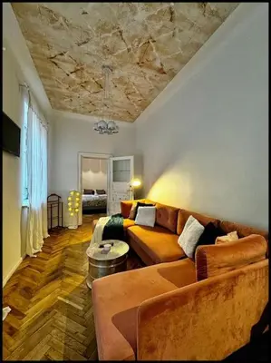 a living room with a couch and a ceiling at Kauno Centras in Kaunas