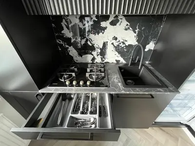 a kitchen with a sink and a counter top at Modernūs apartamentai in Vilkaviškis