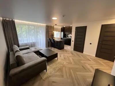 a living room with a couch and a table at Modernūs apartamentai in Vilkaviškis