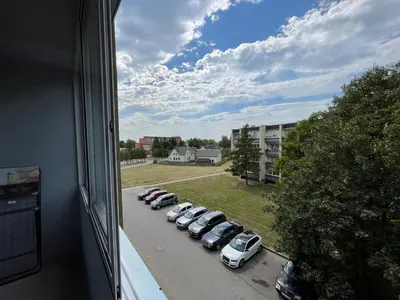 a view of a row of cars parked in a parking lot at Modernūs apartamentai in Vilkaviškis
