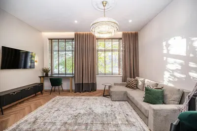 a living room with a couch and a tv at Poppy Apartments in Vilnius