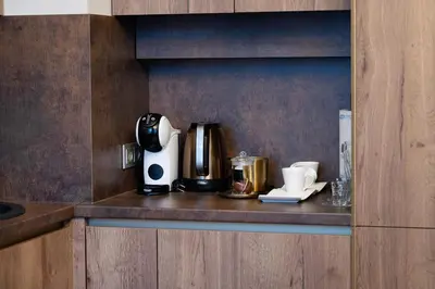 a coffeemaker sitting on a counter in a kitchen at Poppy Apartments in Vilnius