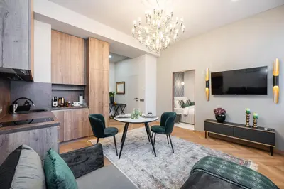 a living room with a table and chairs at Poppy Apartments in Vilnius