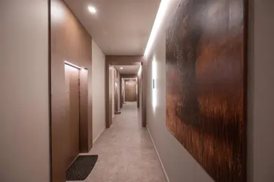 a hallway with a long corridor with wooden walls at Poppy Apartments in Vilnius