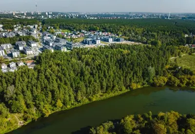 an aerial view of a lake and buildings at Riverside Retreat Near City in VNO