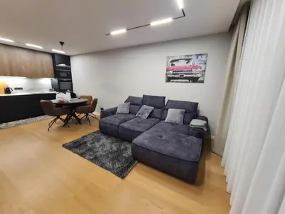 a living room with a couch and a table at Riverside Retreat Near City in VNO