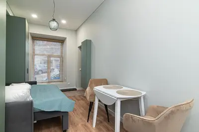 a bedroom with a bed and a table and chairs at Flowers Studio in Vilnius