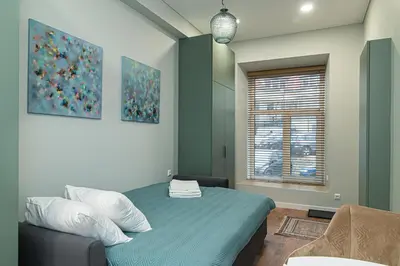 a bedroom with a bed and a window at Flowers Studio in Vilnius