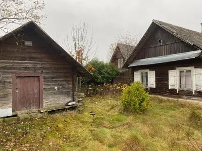 an old wooden house with a door in a yard at Daffaydaffay in Kruminiai