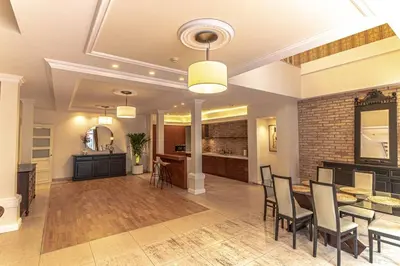 a living room with a table and chairs and a kitchen at Luxury & Best location in Vilnius