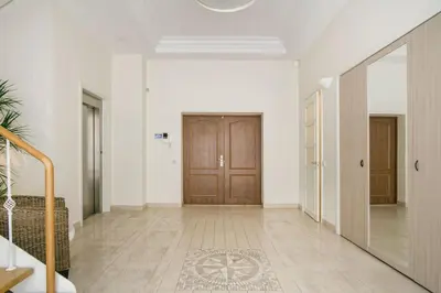 a hallway with a wooden door and a mirror at Luxury & Best location in Vilnius
