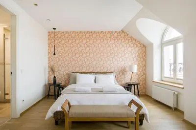 a bedroom with a large bed and a window at Luxury & Best location in Vilnius