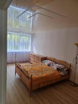 a bedroom with a bed and a large window at Kaunas 174 in Kaunas