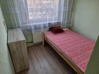 a small bed in a room with a window at Kaunas 174 in Kaunas