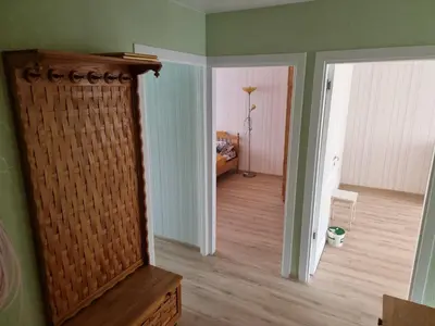 a living room with a mirror and a hallway at Kaunas 174 in Kaunas