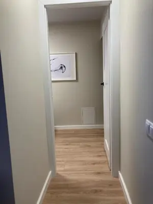 an empty hallway with a painting on the wall at Kaja Home in Šiauliai