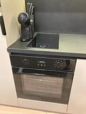 a stove top oven sitting in a kitchen at Kaja Home in Šiauliai