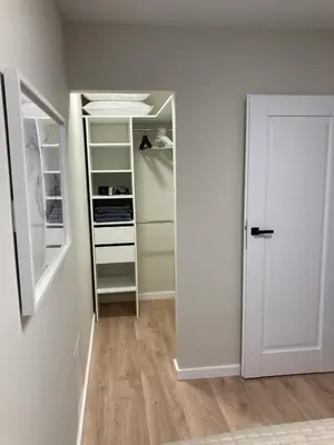 a room with an empty refrigerator and a door at Kaja Home in Šiauliai