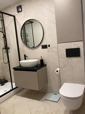 a bathroom with a sink and a mirror at Kaja Home in Šiauliai