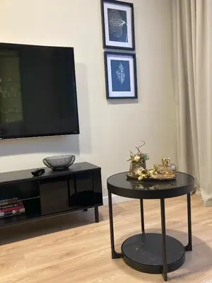 a living room with a tv and a table at Kaja Home in Šiauliai