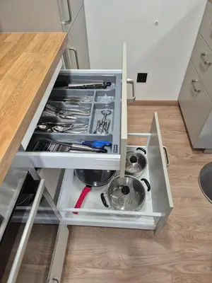 an open drawer in a kitchen with utensils at New Kreves apartment & Free parking & Self check-in in Kaunas