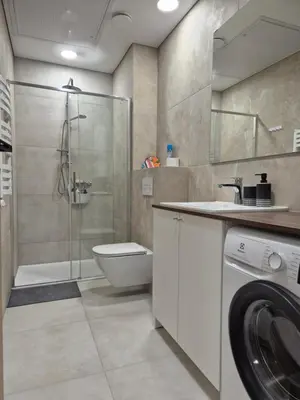 a bathroom with a shower toilet and a sink at New Kreves apartment & Free parking & Self check-in in Kaunas