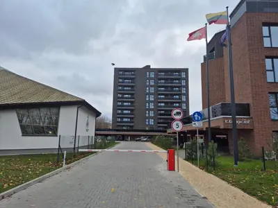 an empty street with two flags and a building at New Kreves apartment & Free parking & Self check-in in Kaunas