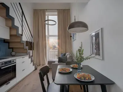 a living room with a table with two plates of food at Loft 59 with Free Parking in Vilnius