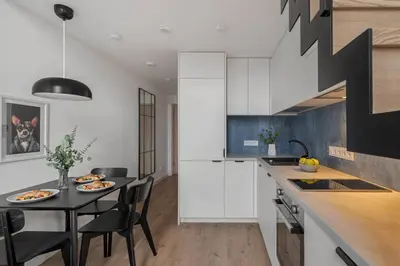 a kitchen with a table and chairs in a kitchen at Loft 59 with Free Parking in Vilnius