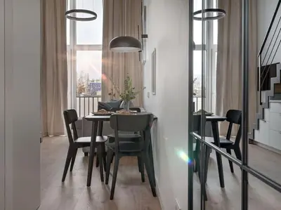 a dining room with a table and chairs and a window at Loft 59 with Free Parking in Vilnius