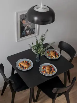 a black table with three plates of food on it at Loft 59 with Free Parking in Vilnius