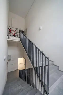 a staircase with a bike on a shelf in a house at Loft 59 with Free Parking in Vilnius