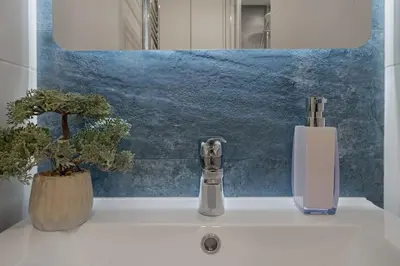 a bathroom sink with a faucet and two plants at Loft 59 with Free Parking in Vilnius