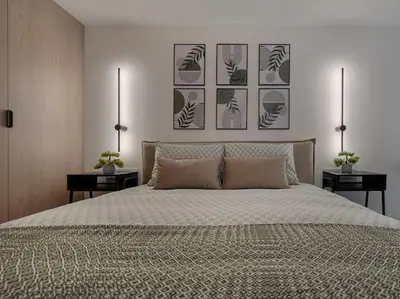 a bedroom with a bed with four pictures on the wall at Brand New 58 Loft with Free Parking in Vilnius